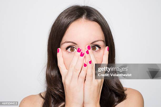 scared girl with pink nails and hand on face. - pink nail polish stock pictures, royalty-free photos & images