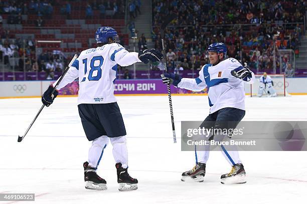 Sami Lepisto of Finland celebrates with teammate Petri Kontiola after scoring a goal in the first period against Bernhard Starkbaum of Austria during...
