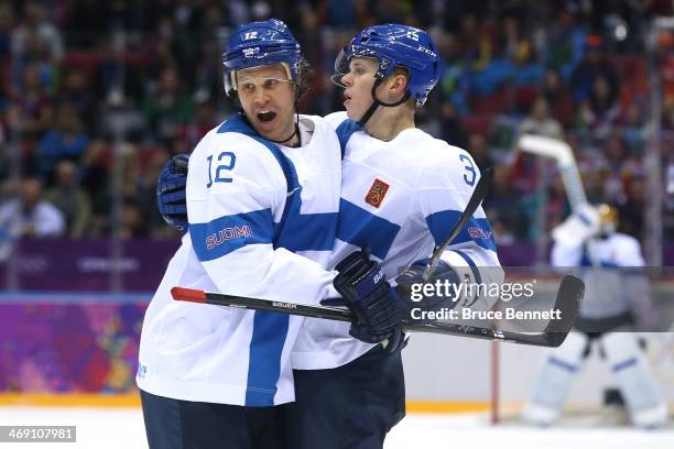 Olli Maatta of Finland celebrates with teammate Olli Jokinen after scoring a goal in the first period against Bernhard Starkbaum of Austria during...