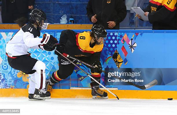 Julia Zorn of Germany handles the puck against Ayaka Toko of Japan in the second period during the women's Ice Hockey Preliminary Round Group B game...
