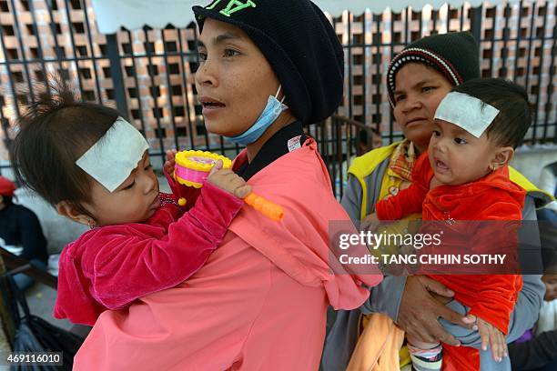 To go with Cambodia-health,FEATURE by Suy SE This photo taken on February 13, 2015 shows Cambodian women with their babies in front of the Kantha...