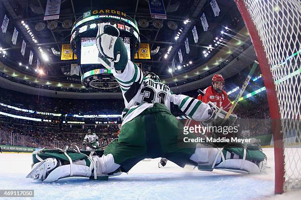 Evan Rodrigues of the Boston University Terriers takes a shot against Zane McIntyre of the North Dakota during the third period of the 2015 NCAA...