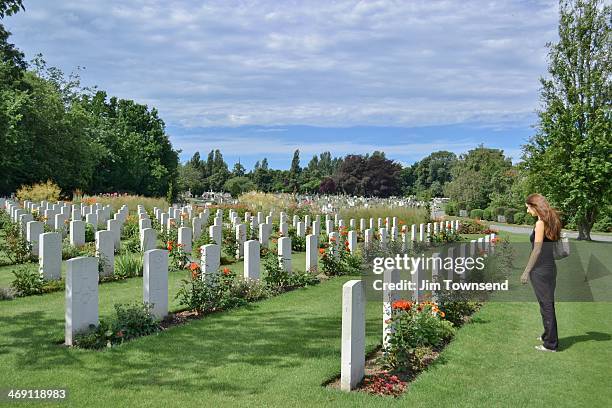 War Memorial and Common Wealth Graves. Rememberance. Remembering the dead. Woman remembers the dead.