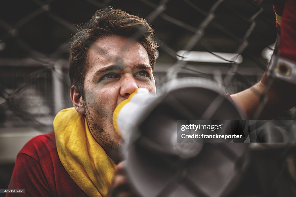 Spanish soccer supporter screaming at the edge of field