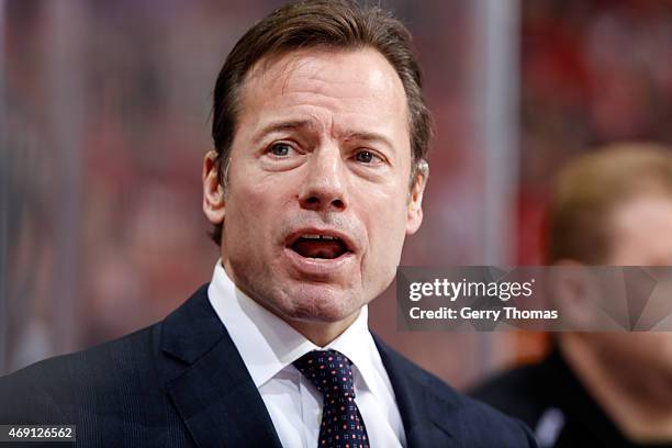 Assistant Coach Martin Gelinas of the Calgary Flames stands on the bench during the game against the Los Angeles Kings at Scotiabank Saddledome on...