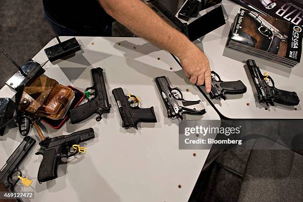 Handguns are organized at the booth of CZ-USA, the US-based subsidiary of Czech arms maker Ceska Zbrojovka A.S., on the exhibition floor ahead of the...