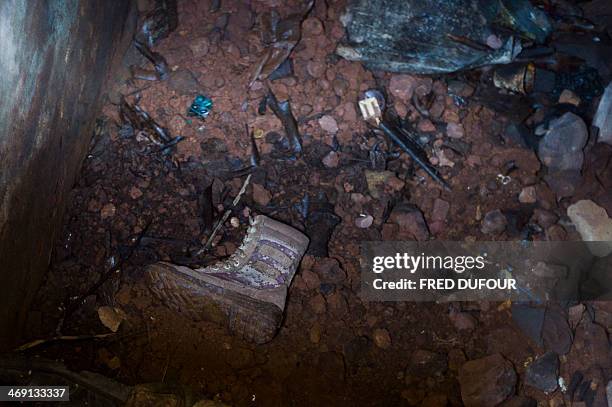Shoe is pictured near dead bodies in a petrol tank in a former military camp used by ex seleka rebels, in Bangui, on February 13, 2014. The head of...