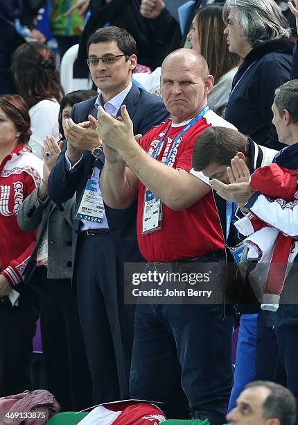 Olympians Alexander Popov and Alexander Karelin of Russia attend the Figure Skating Pairs Free Program on day 5 of the Sochi 2014 Winter Olympics at...