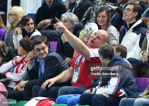 Olympians Alexander Popov, Alexander Karelin and abovee them Yelena Isinbayeva of Russia attend the Figure Skating Pairs Free Program on day 5 of the...