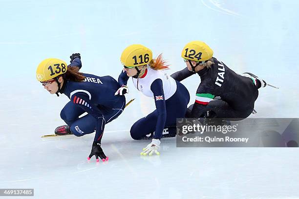 Elise Christie of Great Britain falls and collides with Seung-Hi Park of South Korea and Arianna Fontana of Italy as she competes in the Short Track...