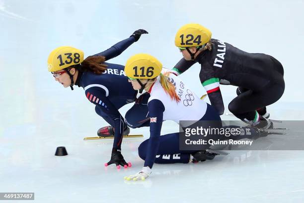 Elise Christie of Great Britain falls and collides with Seung-Hi Park of South Korea and Arianna Fontana of Italy as she competes in the Short Track...