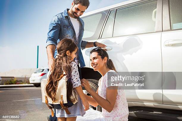 young family taking daughter to school by car - arab family outdoor bildbanksfoton och bilder