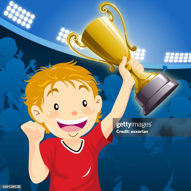 teenage boy winner holding up the trophy at the stadium - pep rally stock illustrations