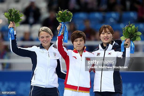 Silver medalist Arianna Fontana of Italy, gold medalist Jianrou Li of China and bronze medalist Seung-Hi Park of Korea during the flower ceremony for...