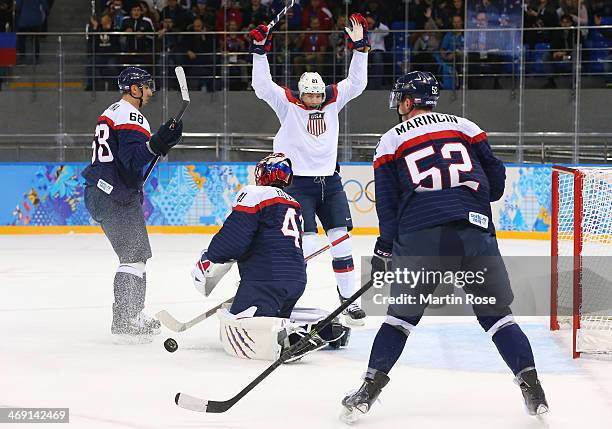 James van Riemsdyk of United States celebrates after John Carlson of United States scores a goal against Jaroslav Halak of Slovakia in the first...