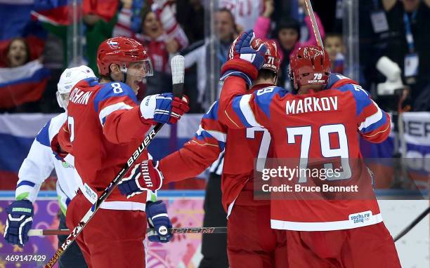 Ilya Kovalchuk of Russia celebrates scoring a goal in the second period with Alexander Ovechkin and Andrei Markov against Slovenia during the Men's...