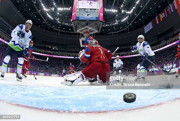 Ziga Jeglic of Slovenia scores a goal in the second period against Semyon Varlamov of Russia during the Men's Ice Hockey Preliminary Round Group A...