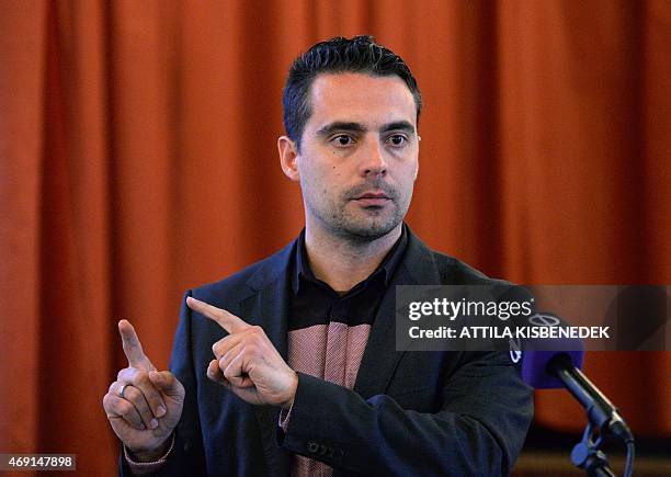 Chairman of the far-right parliamentary JOBBIK party, Gabor Vona, talks about the party program in front of their party candidate Lajos Rig's poster...