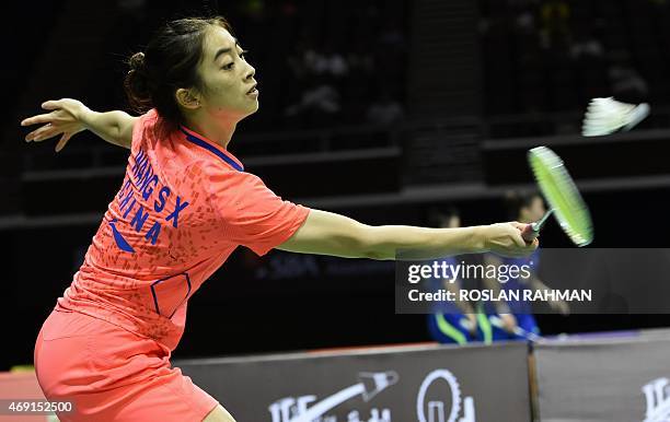 China's Wang Shixian plays against Japan's Akane Yamaguchi in their women's single quarter-finals of the Singapore Open on April 10, 2015. AFP PHOTO...