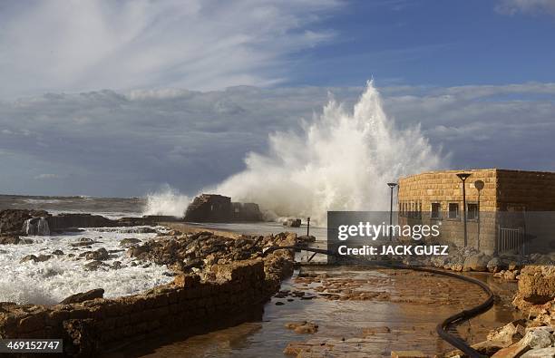 Waves smash into breakers protecting the Roman-era port of Caesarea on December 13, 2010 after a massive storm battering the eastern Mediterranean...