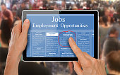 Reading online job ads on a computer tablet -
