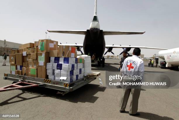 Emergency medical aid from the International Committee of the Red Cross is unloaded from a plane at the international airport in Sanaa on April 10,...