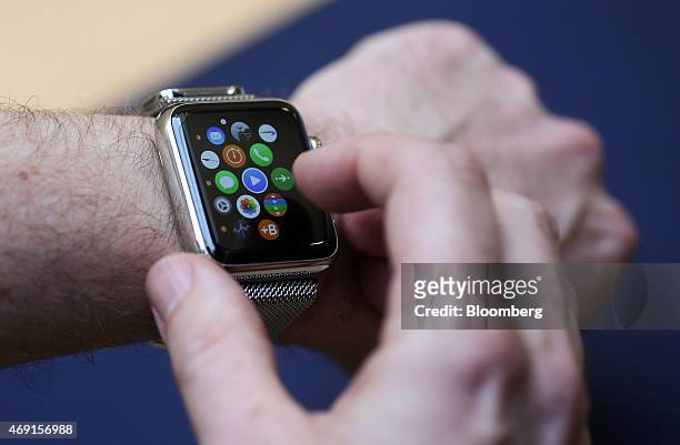 Customer tries the different functions of a new Apple Watch smartwatch during a preview event at Apple Inc.'s Covent Garden store in London, U.K., on...
