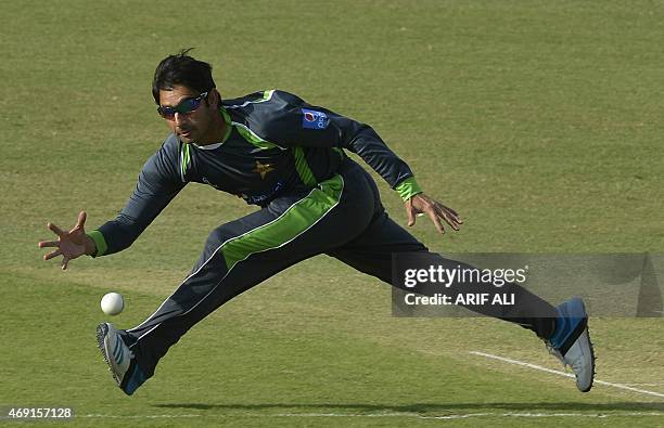 Pakistani cricketer Saeed Ajmal fields the ball during a team practice match in Lahore on April 10, 2015. Pakistani cricket head coach Waqar Younis...