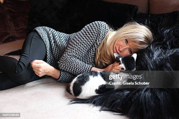 Carmen Geiss poses with her cat during a photo shooting in her house on December 13, 2014 in Valberg, France.