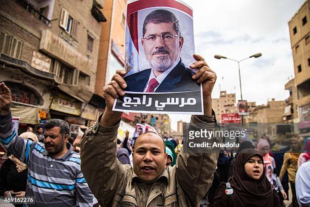 Group of Egyptians who call themselves as 'Anti-Coup demonstrators', hold former Egyptian President Mohamed Morsi's posters and banners as they stage...