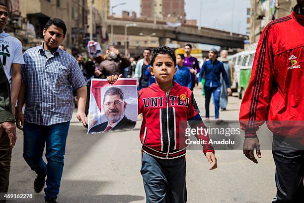 Group of Egyptians who call themselves as 'Anti-Coup demonstrators', hold former Egyptian President Mohamed Morsi's posters and banners as they stage...