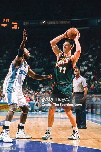 Detlef Schrempf of the Seattle Supersonics looks to move the ball against Glen Rice of the Charlotte Hornets during the game on March 6, 1998 at...