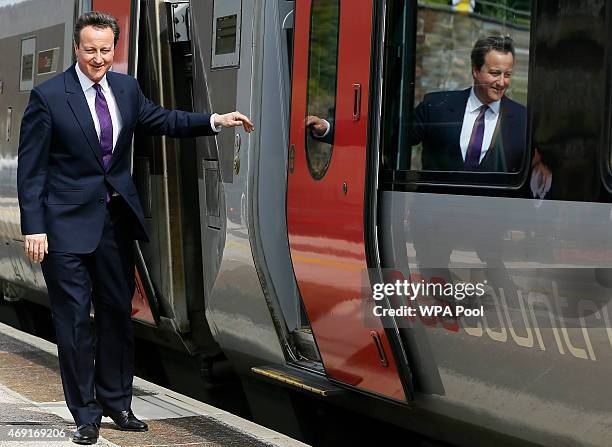 Prime Minister David Cameron steps off a train on April 10, 2015 in Dawlish, United Kingdom. Mr Cameron is touring the country on a campaign trail to...