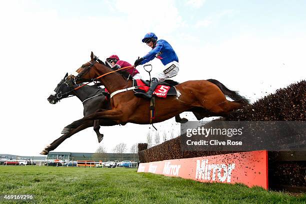 Don Cossack ridden by Tony McCoy and Cue Card ridden by Daryl Jacobs compete in the Betfred Melling Steeple Chase at Aintree Racecourse on April 10,...