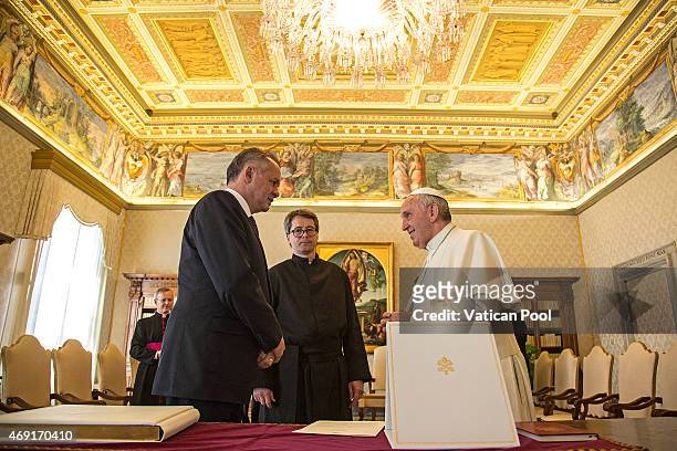 Pope Francis exchanges gifts with President of Slovakia Andrej Kiska during a private audience at the Apostolic Palace on April 9, 2015 in Vatican...