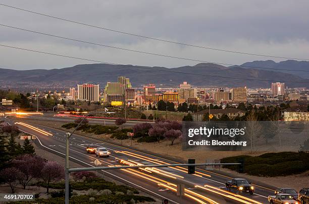 Buildings stand in the skyline of downtown as cars move along the strip in Reno, Nevada, U.S., on Friday, March 20, 2015. Reno, a town that built an...