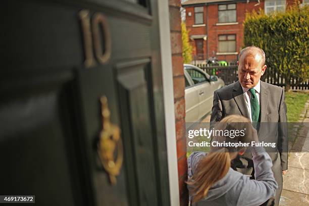 Labour party candidate Simon Danczuk talks to residents as he campaigns on the streets of Rochdale as the second week of electioneering comes to a...