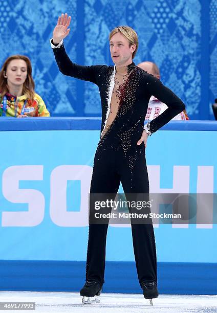 Evgeny Plyushchenko of Russia waves to fans after withdrawing from the competition after warming up during the Men's Figure Skating Short Program on...