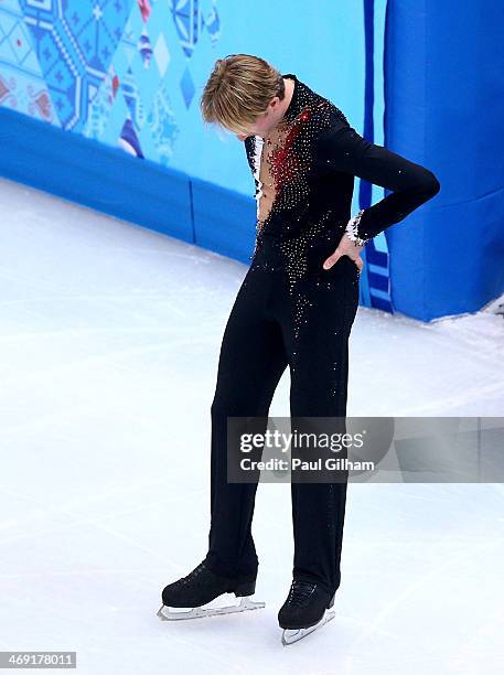 Evgeny Plyushchenko of Russia withdraws from the competition after warming up during the Men's Figure Skating Short Program on day 6 of the Sochi...