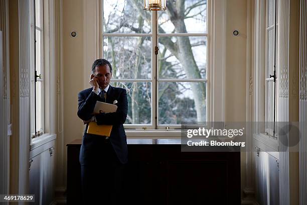 Giuseppe Recchi, chairman of Eni SpA, uses a mobile handset ahead of a news conference in London, U.K., on Thursday, Feb. 13, 2014. Eni SpA, Italy's...