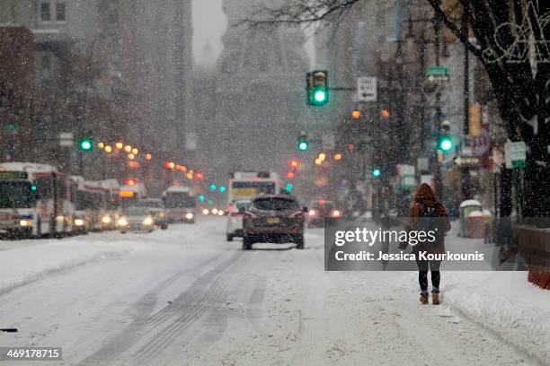 Residents walk through the snow covered streets on February 13, 2014 in Philadelphia, Pennsylvania. The east coast was hit with a winter snowstorm...