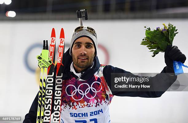 Gold medalist Martin Fourcade of France celebrates on the podium during the flower ceremony for the Men's Individual 20 km during day six of the...