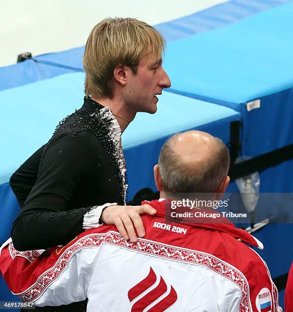 Russias Evgeny Plushenko withdraws from the men's short program figure skating at the Iceberg Skating Palace during the Winter Olympics in Sochi,...