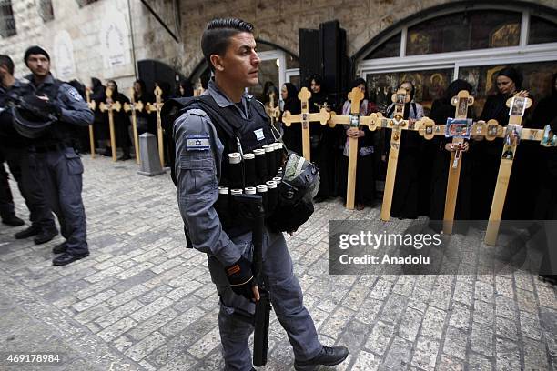 Israeli police stand guard as the Serbian Orthodox Christians carry wooden crosses as they walk along the Via Dolorosa for the remembrance of the...