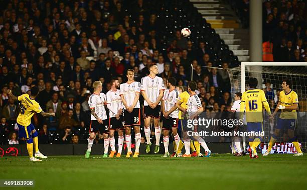 Jermaine Pennant of Wigan Athletic scores their first and equalising goal from a free kick during the Sky Bet Championship match between Fulham and...