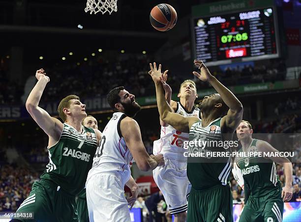 Real Madrid's Greek centre Ioannis Bourousis and Real Madrid's US guard Jaycee Carroll vie with Zalgiris Kaunas' center Arturas Gudaitis and Zalgiris...