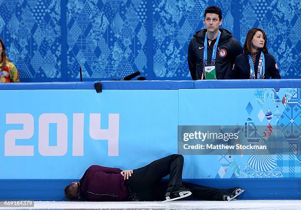 Jeremy Abbott of the United States hits the wall in front of his coaches Yuka Sato and Jason Dungjen while competing during the Men's Figure Skating...