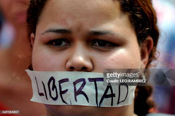 Student with a tape that reads "Freedom" across her mouth takes part in a protest for the student killed during the demonstration on the eve against...