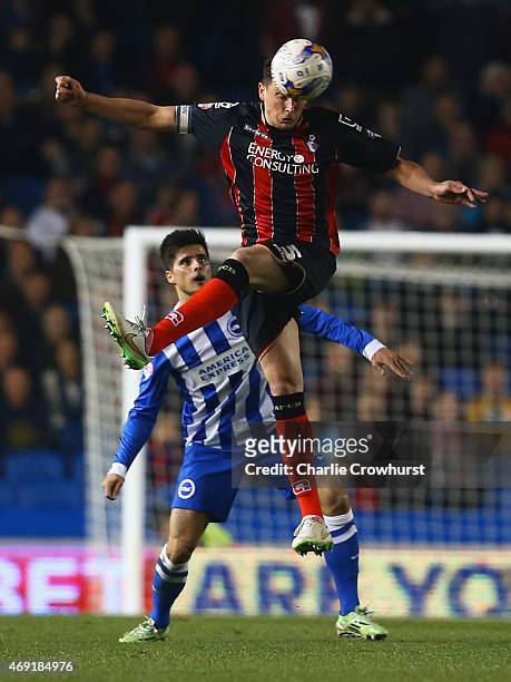 Tommy Elphick of Bournemouth beats Joao Carlos Teixeira of Brighton and Hove Albion to the ball during the Sky Bet Championship match between...