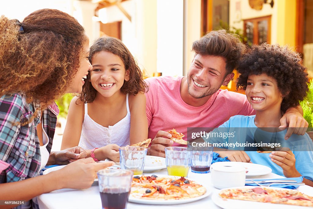 Family gathered at an outdoor restaurant to share a meal